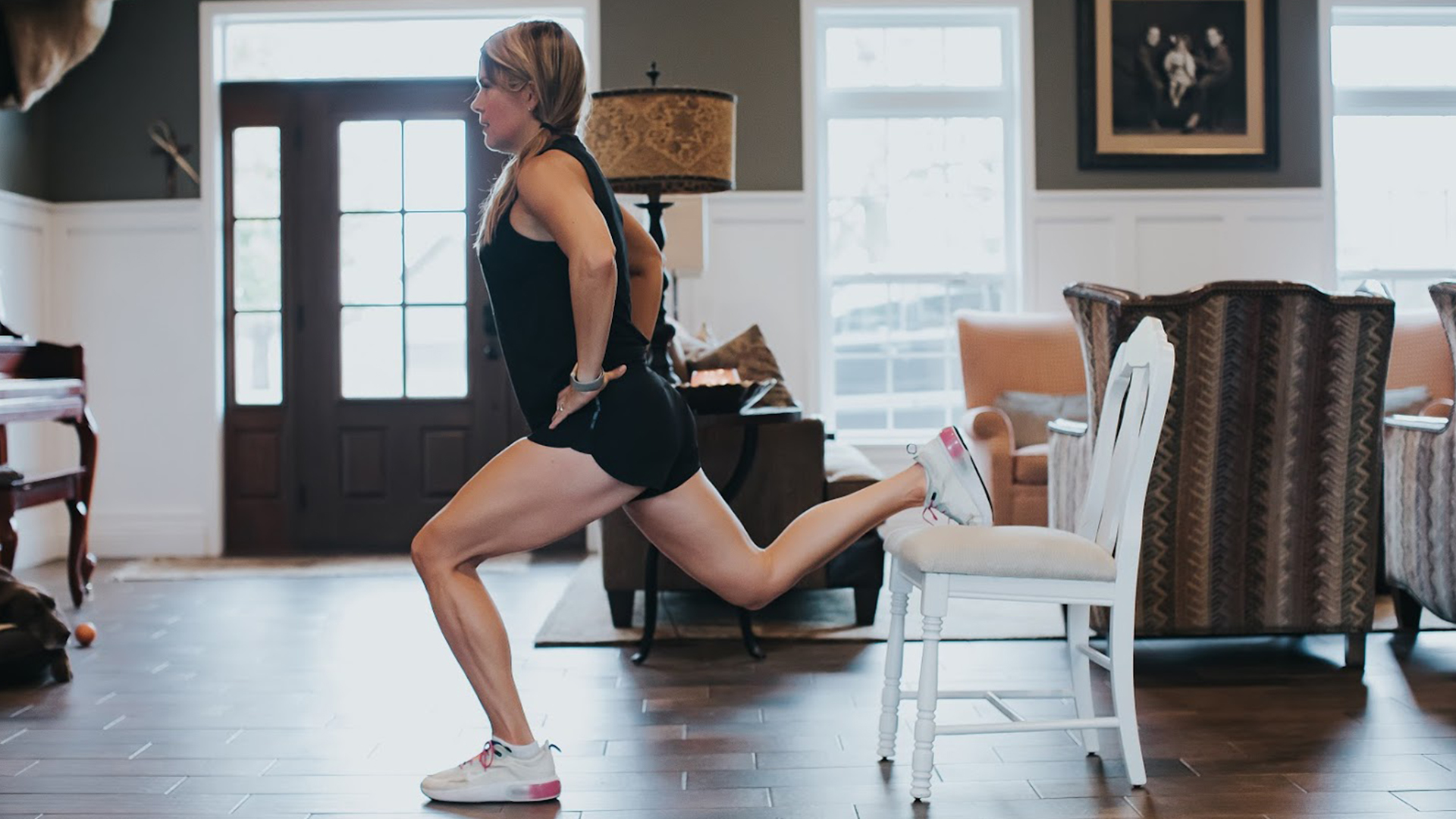 Jill Lewis working out at home with a dining chair